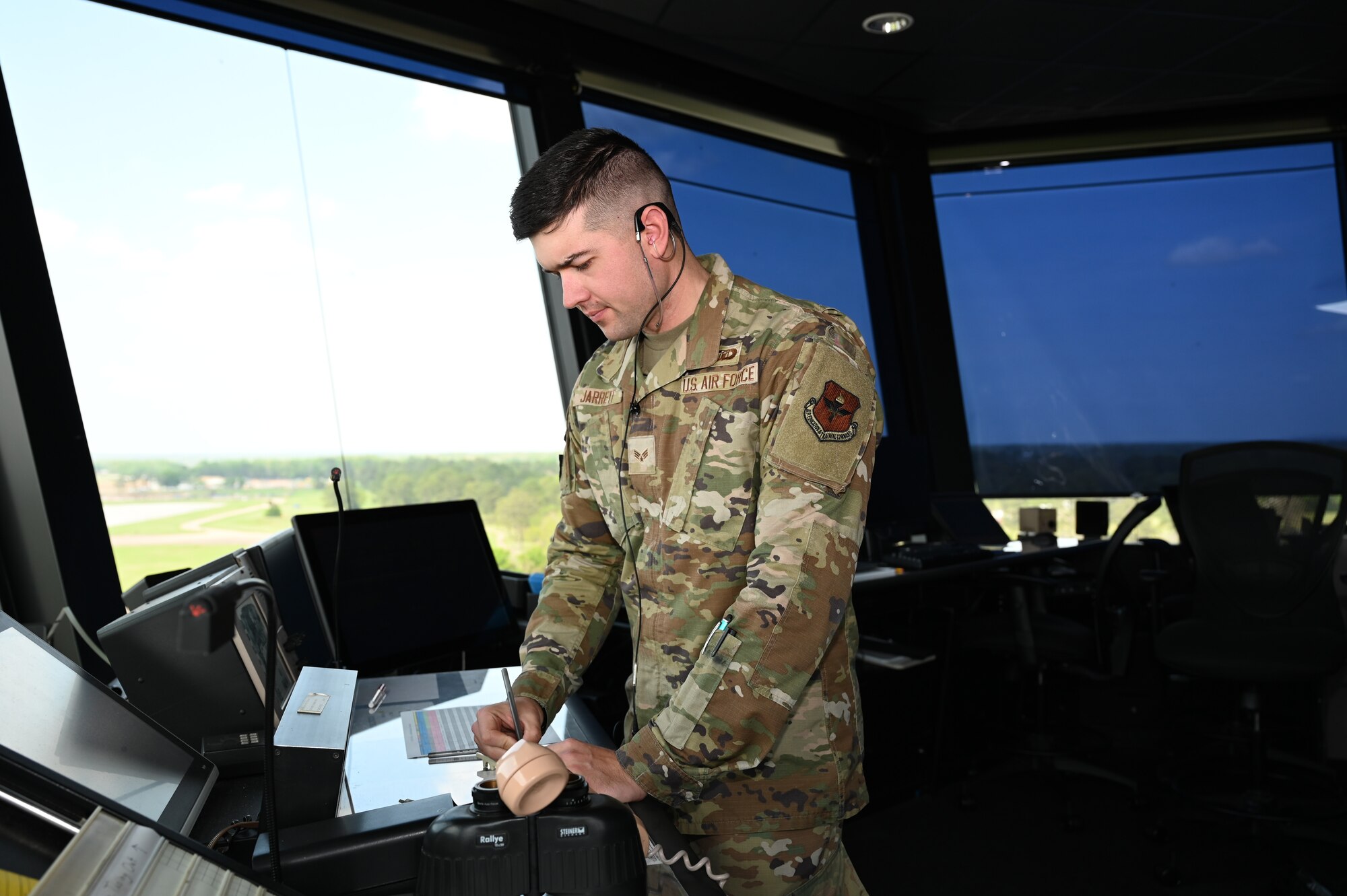 U.S. Air Force Senior Airman Logan Jarrett, 42nd Operations Support Squadron air traffic controller, writes down information at Maxwell Air Force Base, Alabama, April 1, 2025.