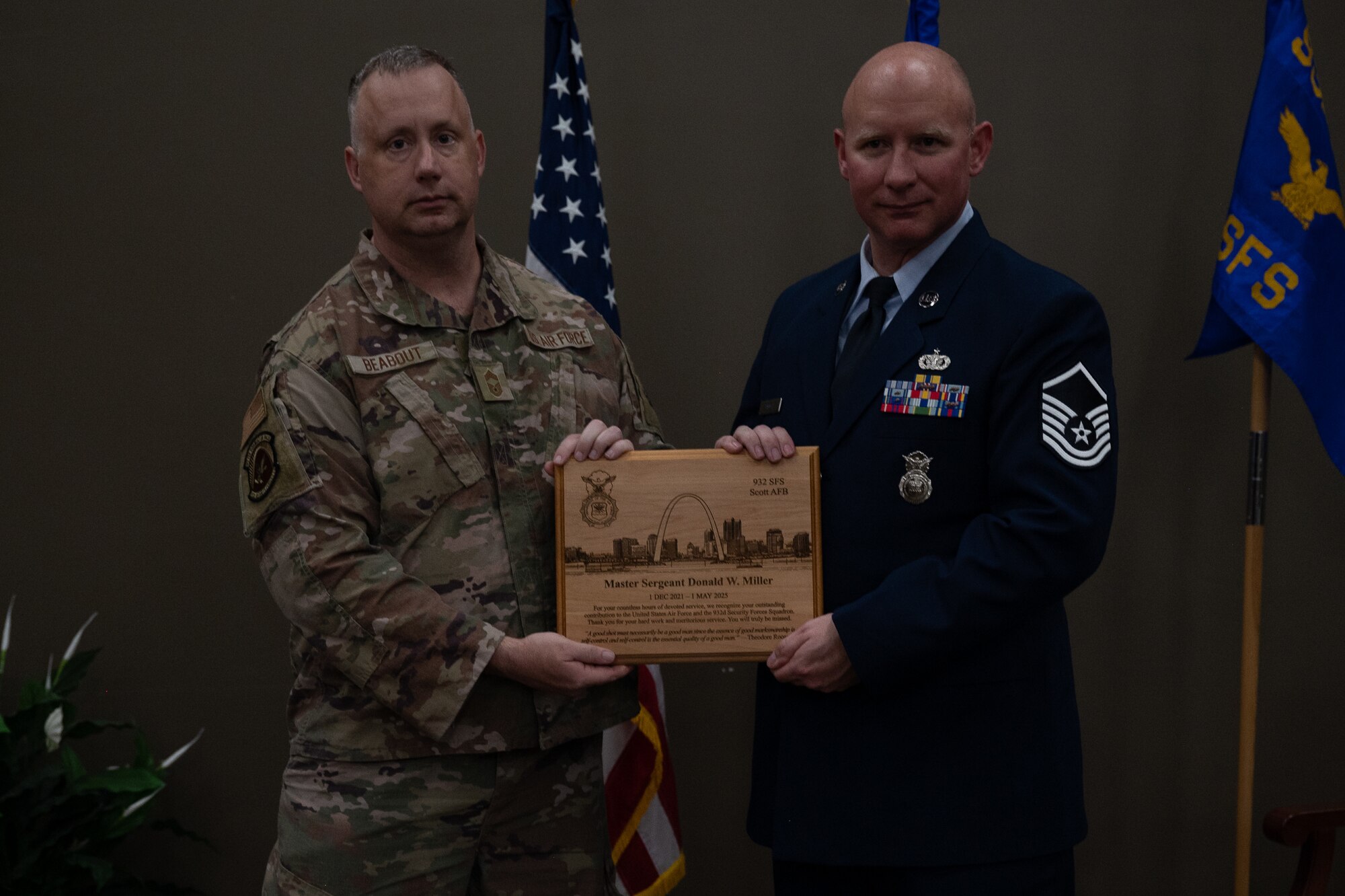 Chief Master Sgt. Robert Beabout, 932nd Security Forces Squadron, presented Master Sgt. Donald Miller, 932nd SFS, with a retirement gift during a ceremony April 5, 2025, Scott Air Force Base, Illinois. Miller received a custom plaque from Chief Master Sgt. Robert Beabout for his hardwork and dedication  in the SFS. (U.S. Air Force photo by Senior Airman Benjamin Cowles)