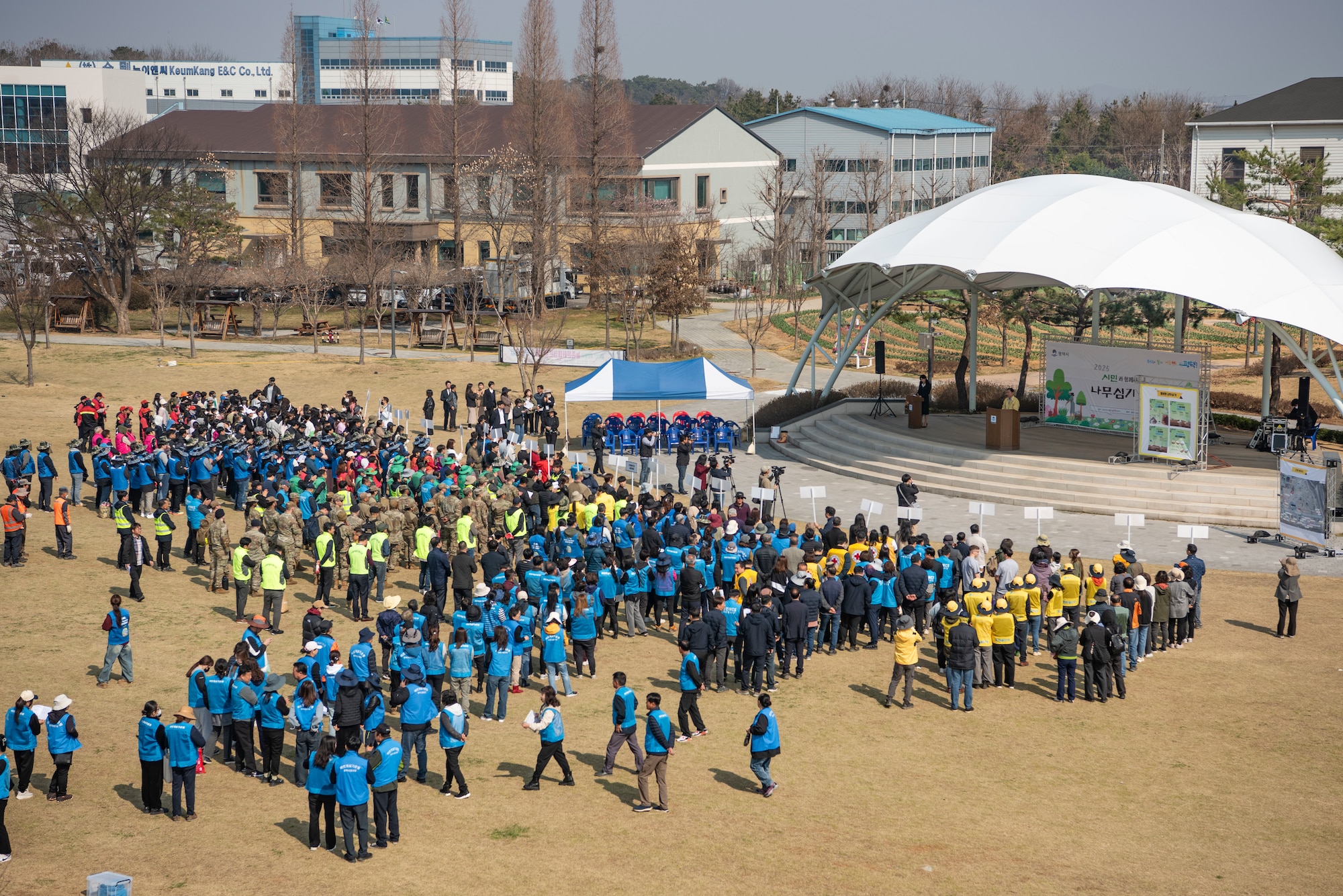 Members of the Pyeongtaek community and U.S. Airmen assigned to the 51st Fighter Wing gather for opening remarks during the 80th Arbor Day event in Pyeongtaek, Republic of Korea, March 31, 2025.