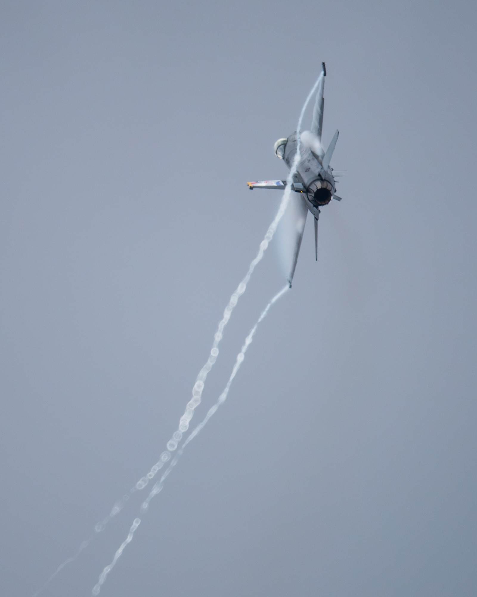 fighter jet flies through the sky
