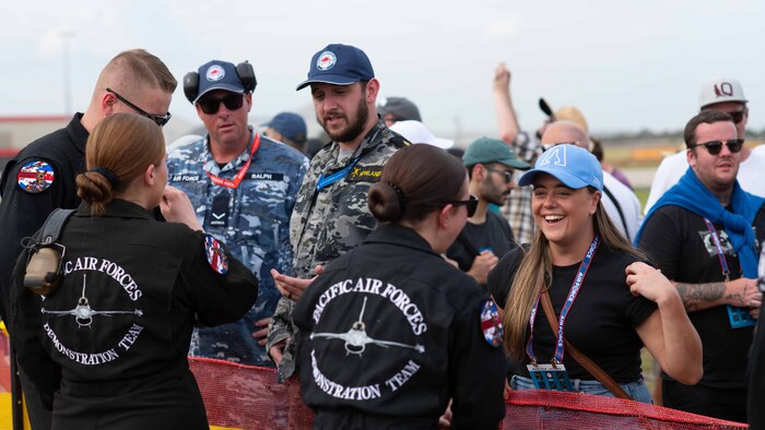 U.S. Airmen and Australian residents and service members engage in conversation