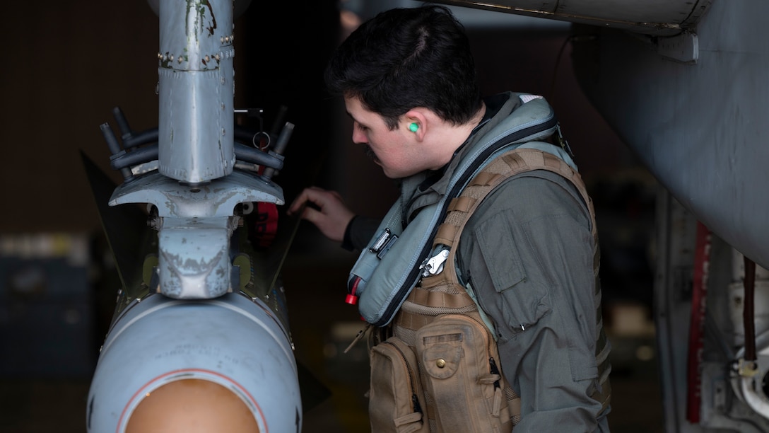 A U.S. Air Force pilot performs pre-flight checks