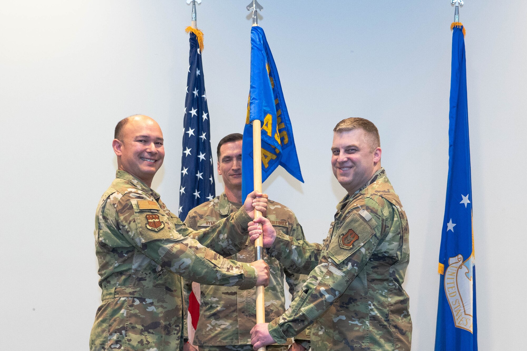 Col. John Benson, 403rd Wing commander, passes the guidon to Col. Adam Hohman, 403rd Aeromedical Staging Squadron commander.
