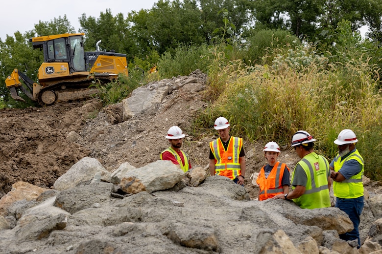 Construction site in partially filled dam spillway