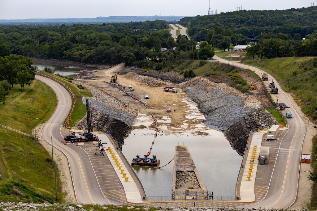 Construction site in partially filled dam spillway