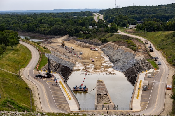 Construction site in partially filled dam spillway