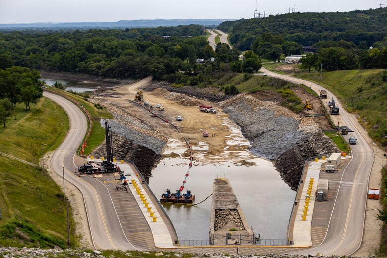 Construction site in partially filled dam spillway
