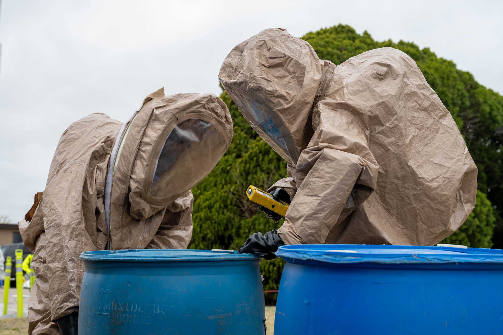 Two Airmen assigned to the 22nd Medical Group identify a container of simulated hazardous material on McConnell Air Force Base, Kansas, March 28, 2025. A blue plastic 55-gallon drum is typically used to store liquid chemicals and solvents. (U.S. Air Force photo by Airman 1st Class Patrick O’Neill)