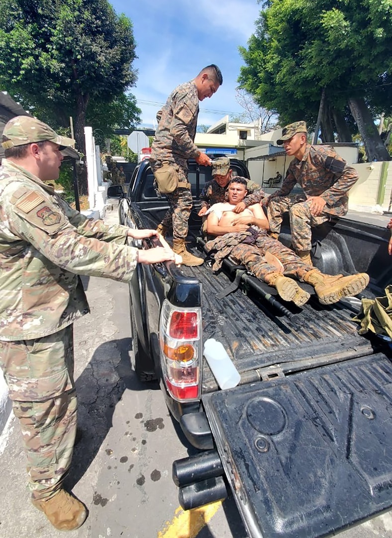 Master Sgt. Shane Bedard, Headquarters, 141st Air Refueling Wing, Washington Air National Guard talks with members of the El Salvador military as they conduct tactical combat casualty care training from Feb. 22 – March 8, 2025.