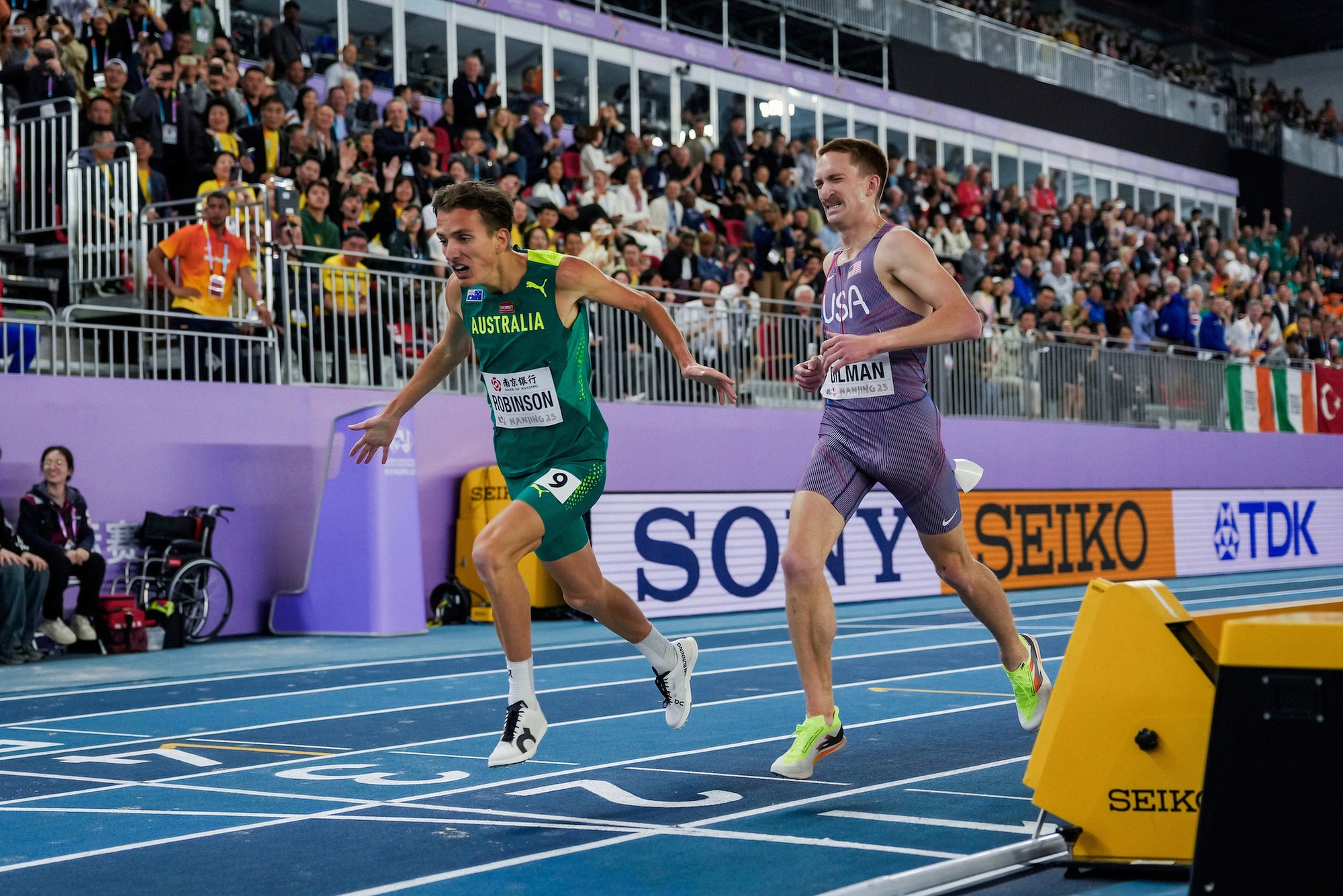 Two men coming into finish line in foot race.
