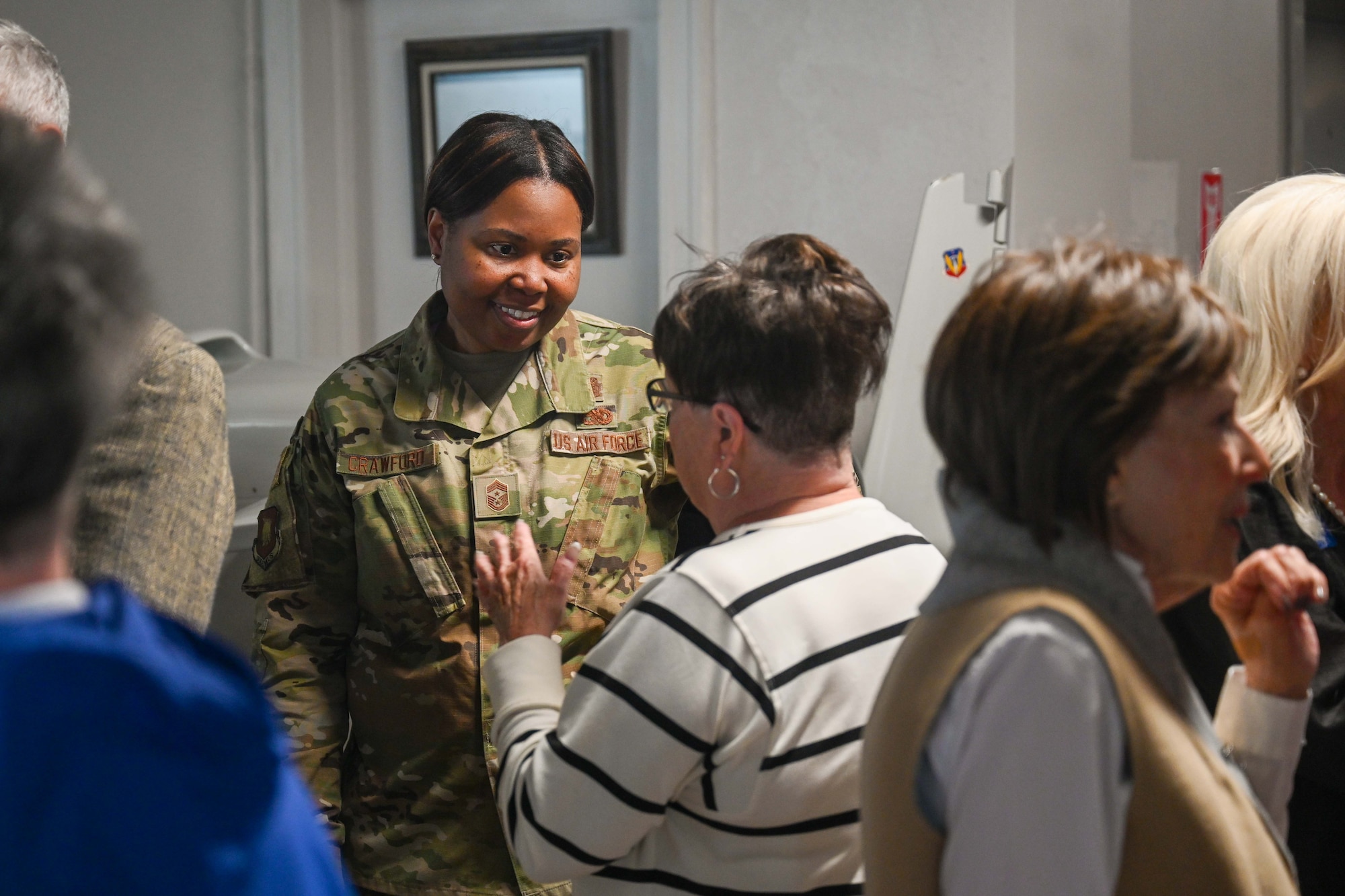Chief Master Sgt. Markeisha Crawford, 22nd Air Refueling Wing command chief, speaks with guests during an event unveiling the new Robin Spurrier exhibit at the Kansas Aviation Museum April 1, 2025, in Wichita, Kansas. The exhibit is now open to the public where visitors can learn more about Spurrier’s legacy and his contributions to Wichita’s global impact on aviation. (U.S. Air Force photo by Senior Airman William Lunn)
