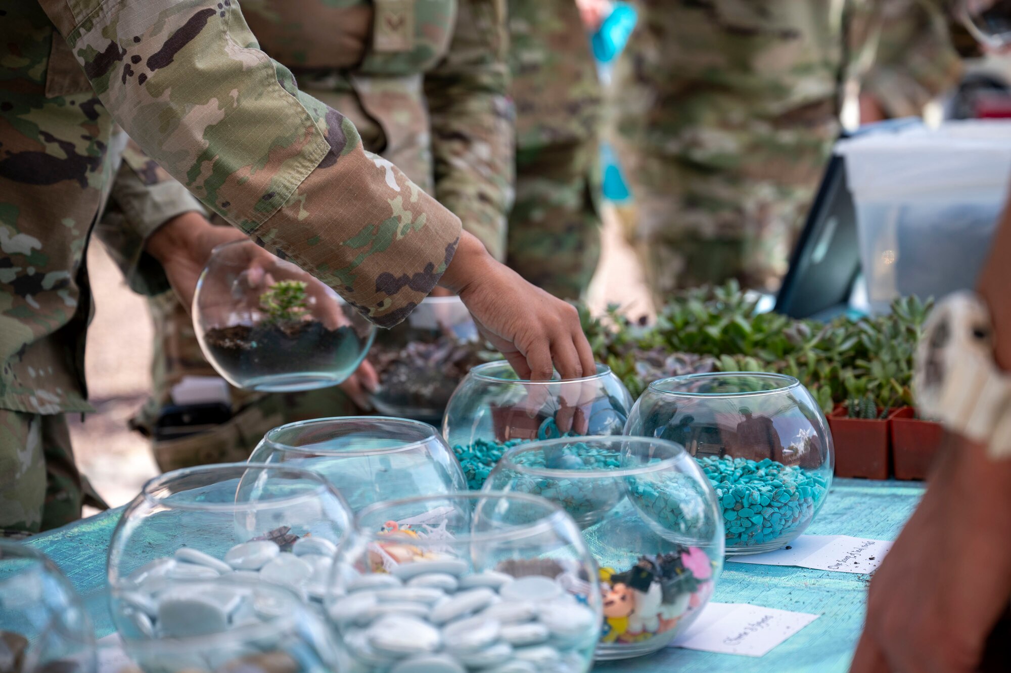 The Sexual Assault Prevention and Response office hosts its annual open house at Davis-Monthan Air Force Base, Arizona, April 4, 2024. Terrariums were featured as part of the open house experience, giving visitors the chance to raise awareness about SAPR and take a souvenir home. (U.S. Air Force photo by Airman Samantha Melecio)