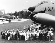 People stand in front of airplane