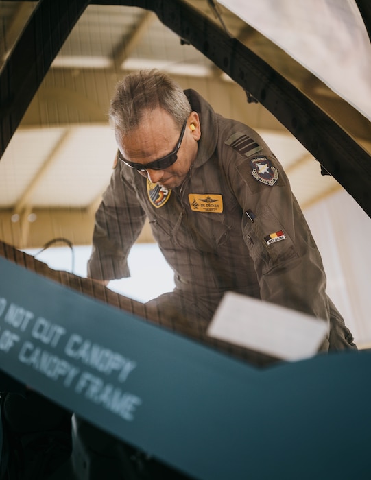 Belgian Air Component Maj. Gen. Geert Decker, Belgium air chief, climbs into the cockpit of a BAC F-35A Lightning II.