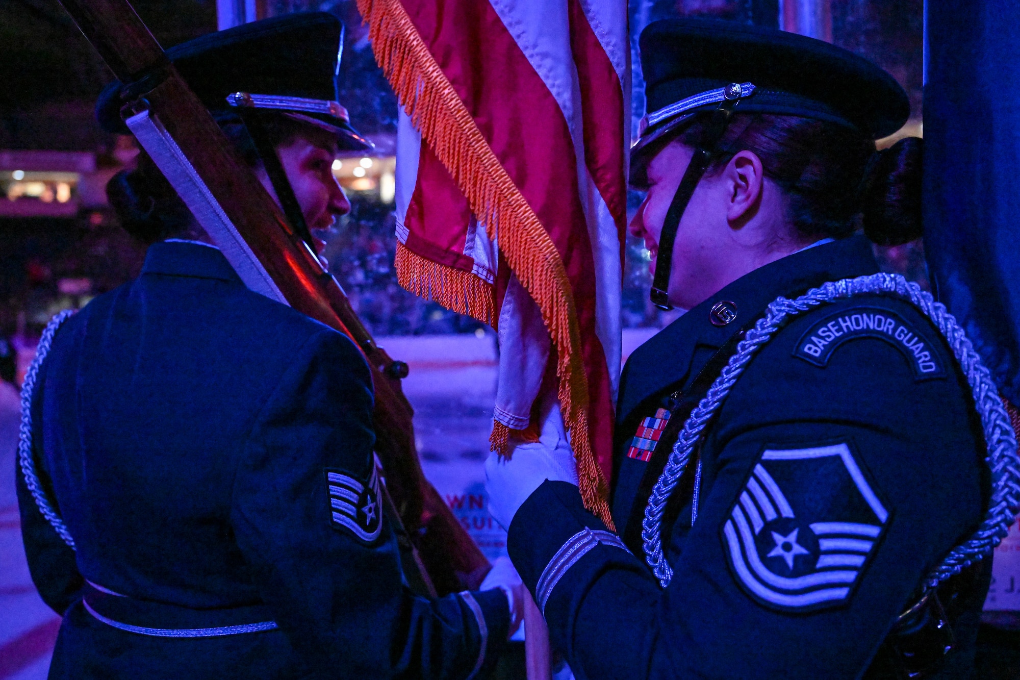 Staff Sgt. Rose Johnson and Master Sgt. Melanierose Mendoza, both members of the 910th Airlift Wing color guard, chat before stepping into the ice rink on April 5, 2025, at the Covelli Centre, Youngstown, Ohio.