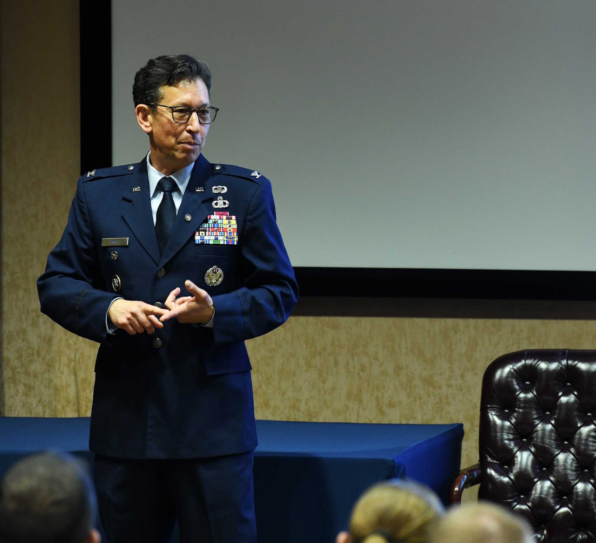 man in military dress uniform addresses an audience