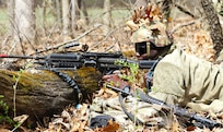 Illinois Army National Guard Spc. Termaine Cunningham mans his position during base defense training at Marseilles Training Area