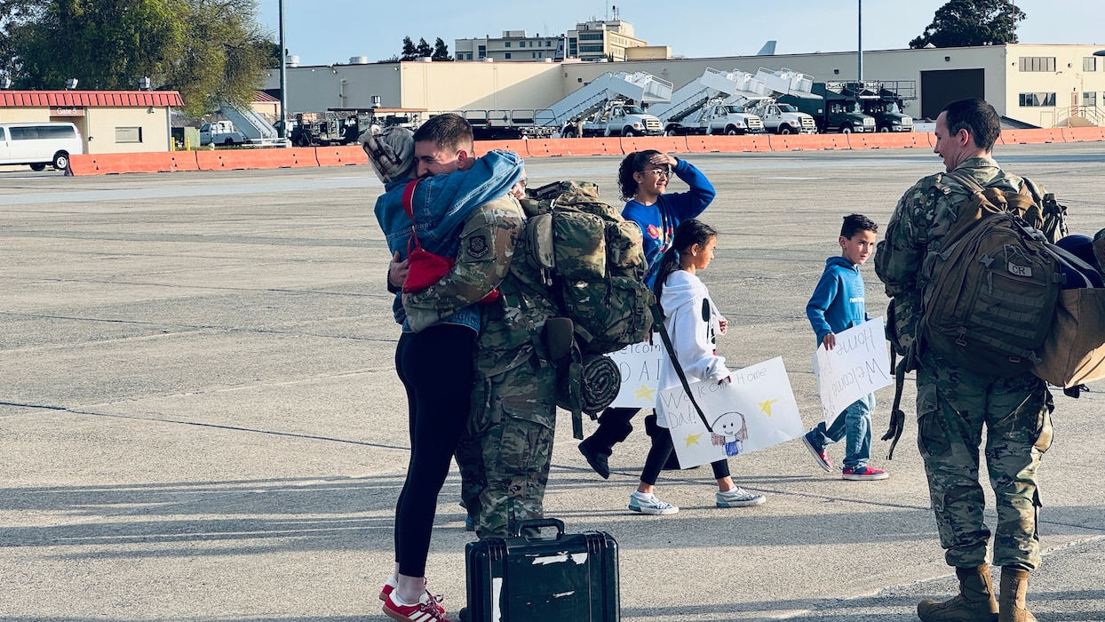 Couple hugs on flightline