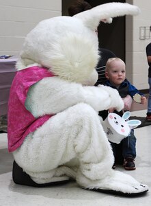The young son of Illinois Army National Guard Sgt. 1st Class Danielle Bauman of Mount Vernon sits with the Easter Bunny at the Illinois National Guard's Easter Egg Hunt for Military Families.