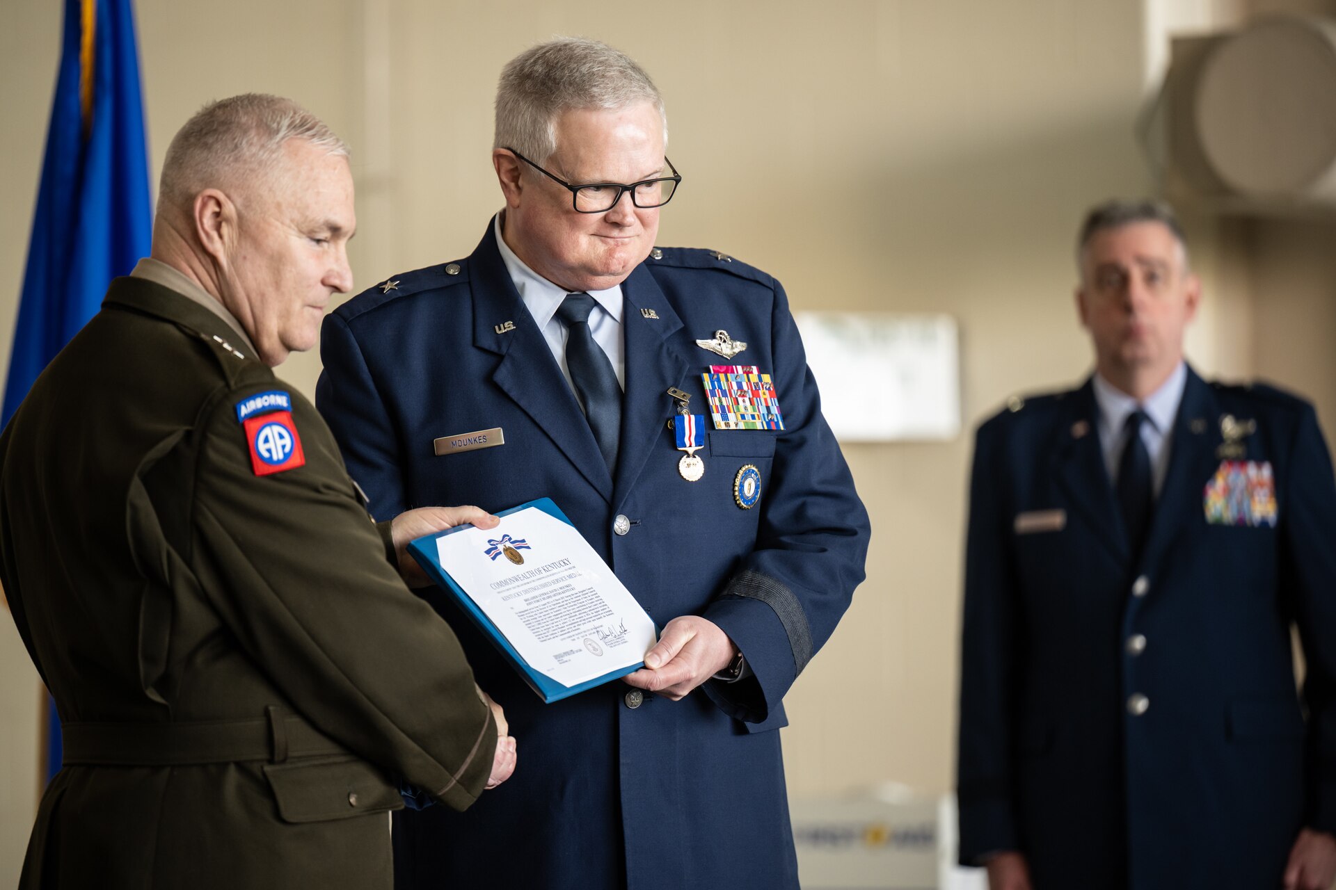 U.S. Air Force Brig. Gen. David Mounkes, right, Kentucky’s outgoing assistant adjutant general for Air, receives the Kentucky Distinguished Service Medal from U.S. Army Maj. Gen. Haldane Lamberton, adjutant general of the Commonwealth of Kentucky, during a ceremony at the Kentucky Air National Guard Base in Louisville, Ky., March 14, 2025.