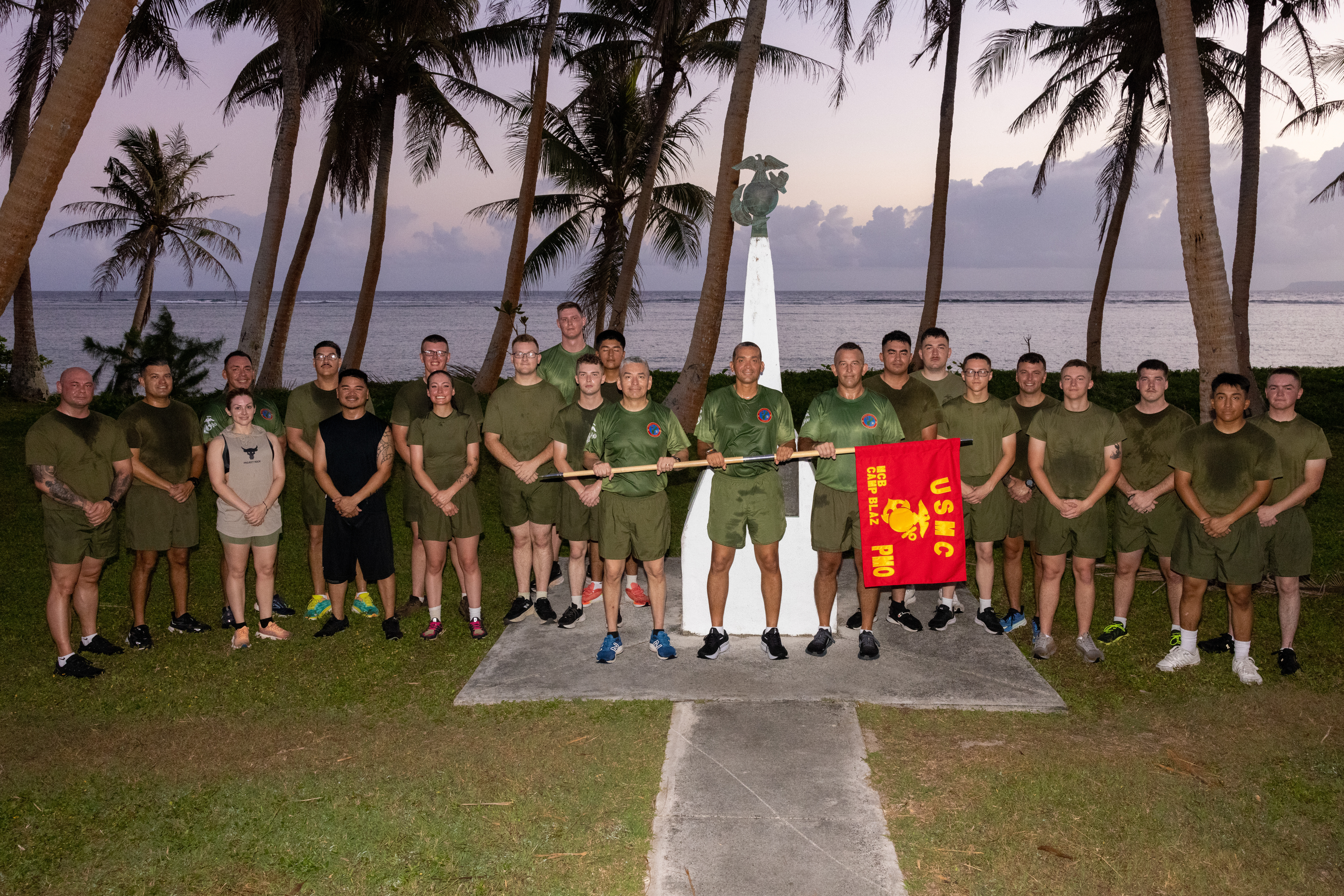 U.S. Marines and civilians with Provost Marshals Office, Marine Corps Base Camp Blaz, and Col. Ernest Govea, commanding officer, MCB Camp Blaz,  pose in front of the Asan Beach landing monument after the Special Olympics Guam torch run in Asan, Guam, March 29, 2025. Special Olympics Guam sponsors an annual track and field event that is preceded by a 15-mile torch run from the main gate of Naval Base Guam to Okkodo High School, Dededo, Guam. (U.S. Marine Corps photo by Cpl. Ryan Little)