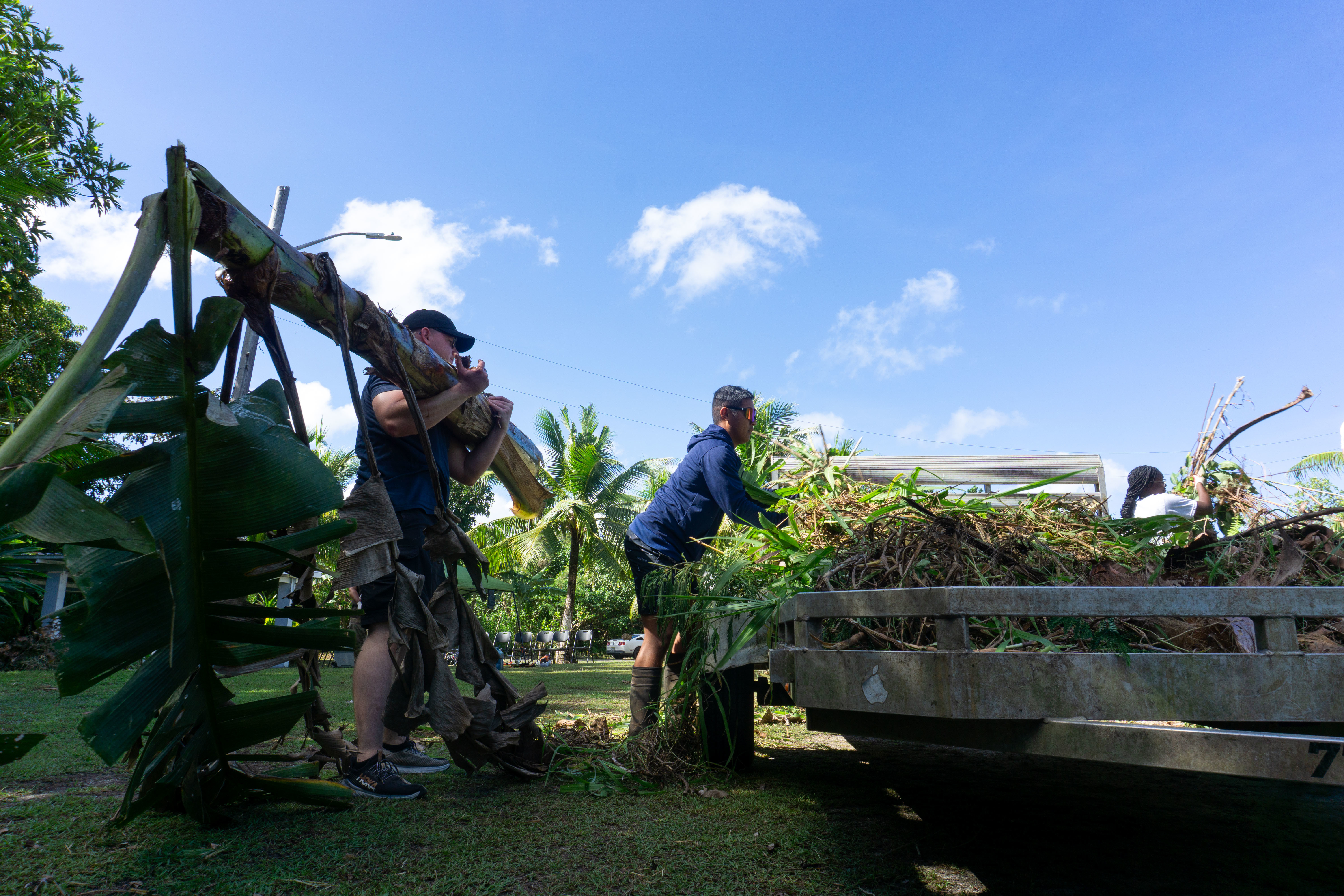 U.S. Marine Cpl. Dylan Hughes, a precision weapons technician with Marine Corps Base Camp Blaz, loads organic debris onto a trailer for removal. Marines recently assisted the village of Piti by participating in a clean-up; this effort showcases the Marines’ commitment and respect towards local communities. (U.S. Marine Corps photo by Chelsey Suarez-Pierce)