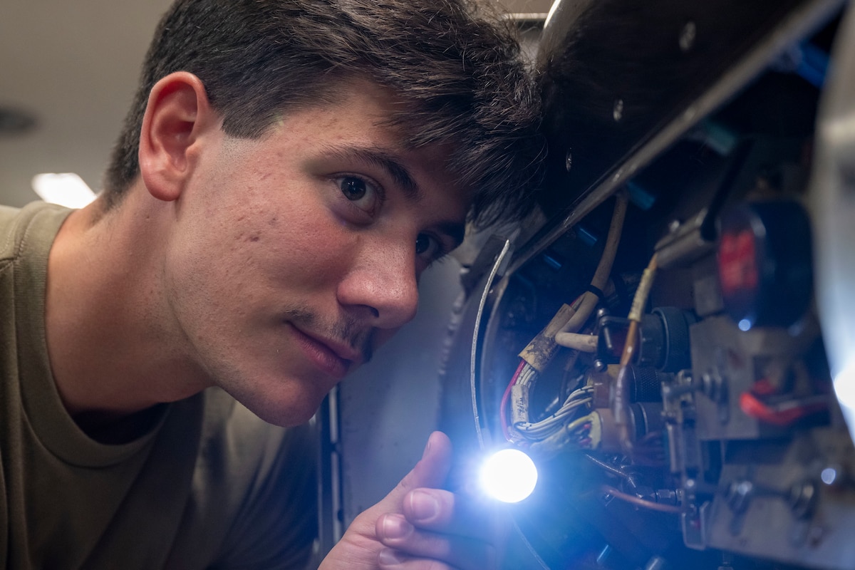 U.S. Air Force Airman Cameron DeGray, 35th Maintenance Squadron avionics flight electronic warfare systems technician, inspects an AN/ALQ-184 electronic countermeasures pod.
