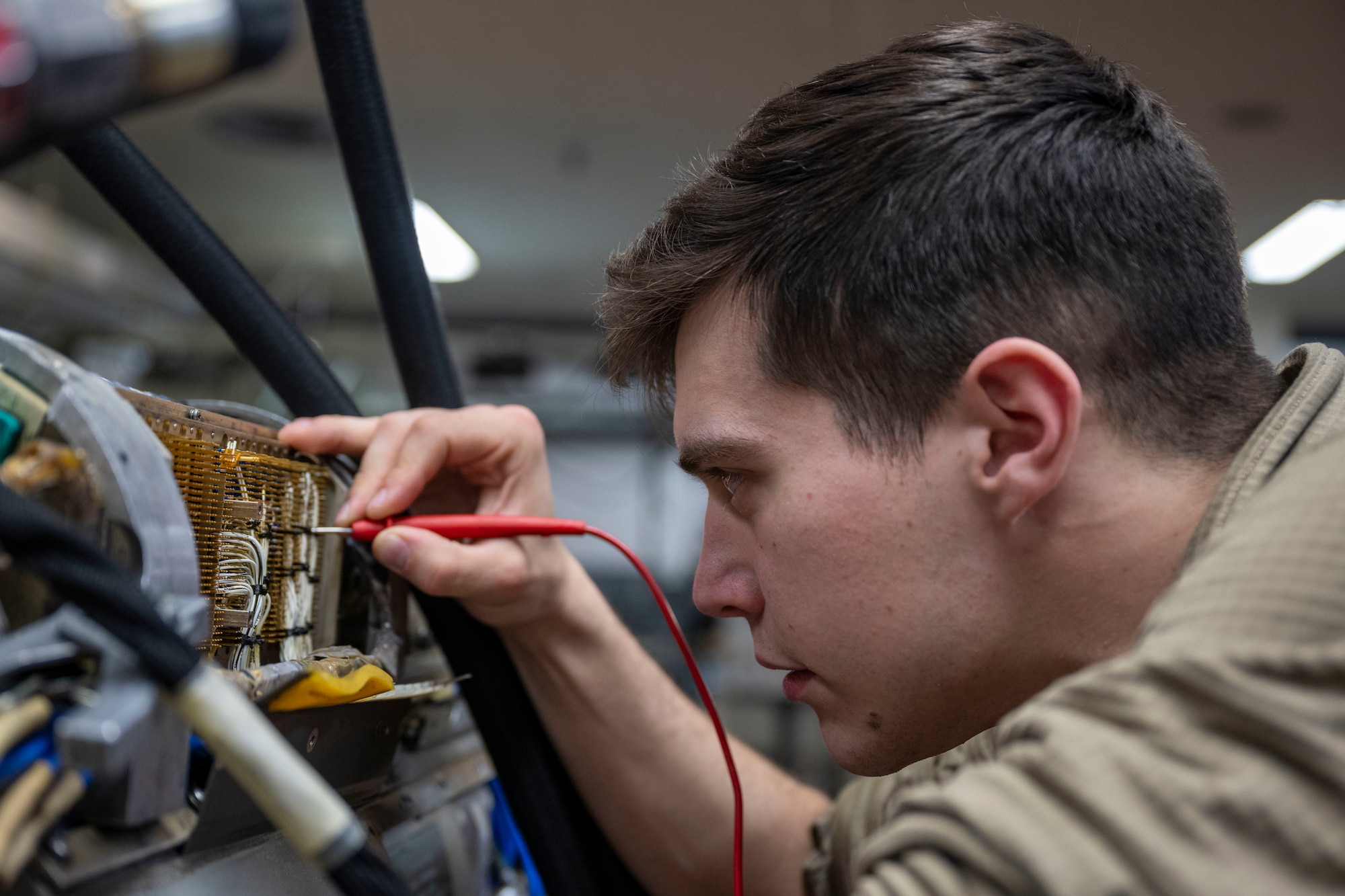 U.S. Air Force Senior Airman Gabriel Garner, 35th Maintenance Squadron avionics flight electronic warfare systems technician, works on an AN/ALQ-184 electronic countermeasures pod.