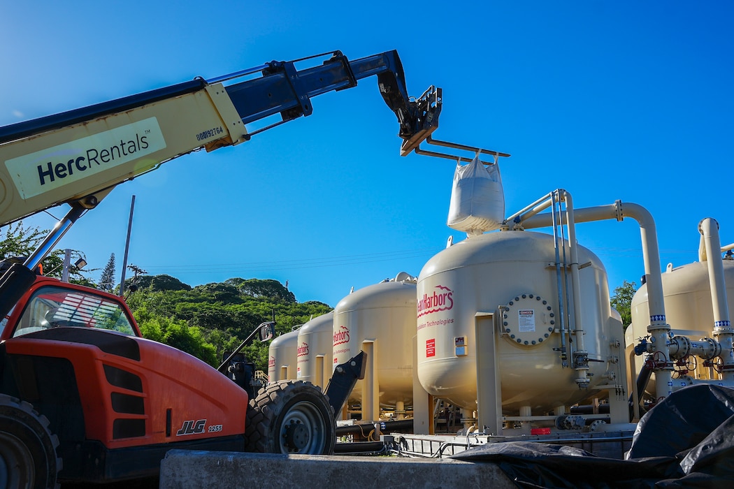 HONOLULU (March 24, 2025) Contractors with Navy Closure Task Force Red-Hill (NCTF-RH) raise a bulk bag of fresh filtration media into a granular activated carbon system (GAC) at the Red Hill Bulk Fuel Storage Facility (RHBFSF), in Honolulu, March 24, 2025. Carbon inside the filtration media removes potential contaminants from the water through adsorption. GAC technicians replace the system with new bags of filtration media approximately every six months. Charged with the safe decommissioning of the facility, NCTF-RH was established by the Department of the Navy as a commitment to the community and the environment, and continues to engage with the people of Hawaii, regulatory agencies, and other stakeholders as it safely and deliberately decommissions the RHBFSF. (U.S. Navy photo by Mass Communication Specialist Seaman Krystal Diaz)