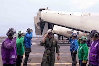 Adm. Steve Koehler, commander, U.S. Pacific Fleet, salutes sideboys on the flight deck of the aircraft carrier USS Nimitz (CVN 68) in the Pacific Ocean, April 4, 2025.