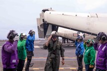 Adm. Steve Koehler, commander, U.S. Pacific Fleet, salutes sideboys on the flight deck of the aircraft carrier USS Nimitz (CVN 68) in the Pacific Ocean, April 4, 2025.