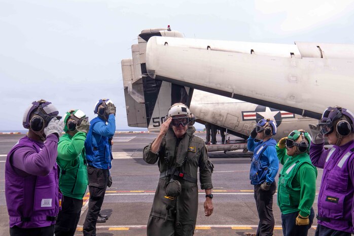 Adm. Steve Koehler, commander, U.S. Pacific Fleet, salutes sideboys on the flight deck of the aircraft carrier USS Nimitz (CVN 68) in the Pacific Ocean, April 4, 2025.