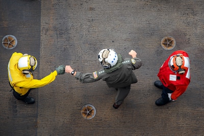 Adm. Steve Koehler, commander, U.S. Pacific Fleet, greets Sailors on the flight deck of the aircraft carrier USS Nimitz (CVN 68) in the Pacific Ocean, April 4, 2025.