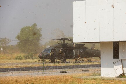 Members of the 1st Battalion, 12th Infantry Regiment, 2nd Stryker Brigade Combat Team, 4th Infantry Division, Fort Carson, Colorado, arrive on the ground in UH-60 Black Hawk helicopters during Military Operations on Urbanized Terrain (MOUT) training with the Royal Thai Army on March 16, 2025, in Lop Buri, Thailand.