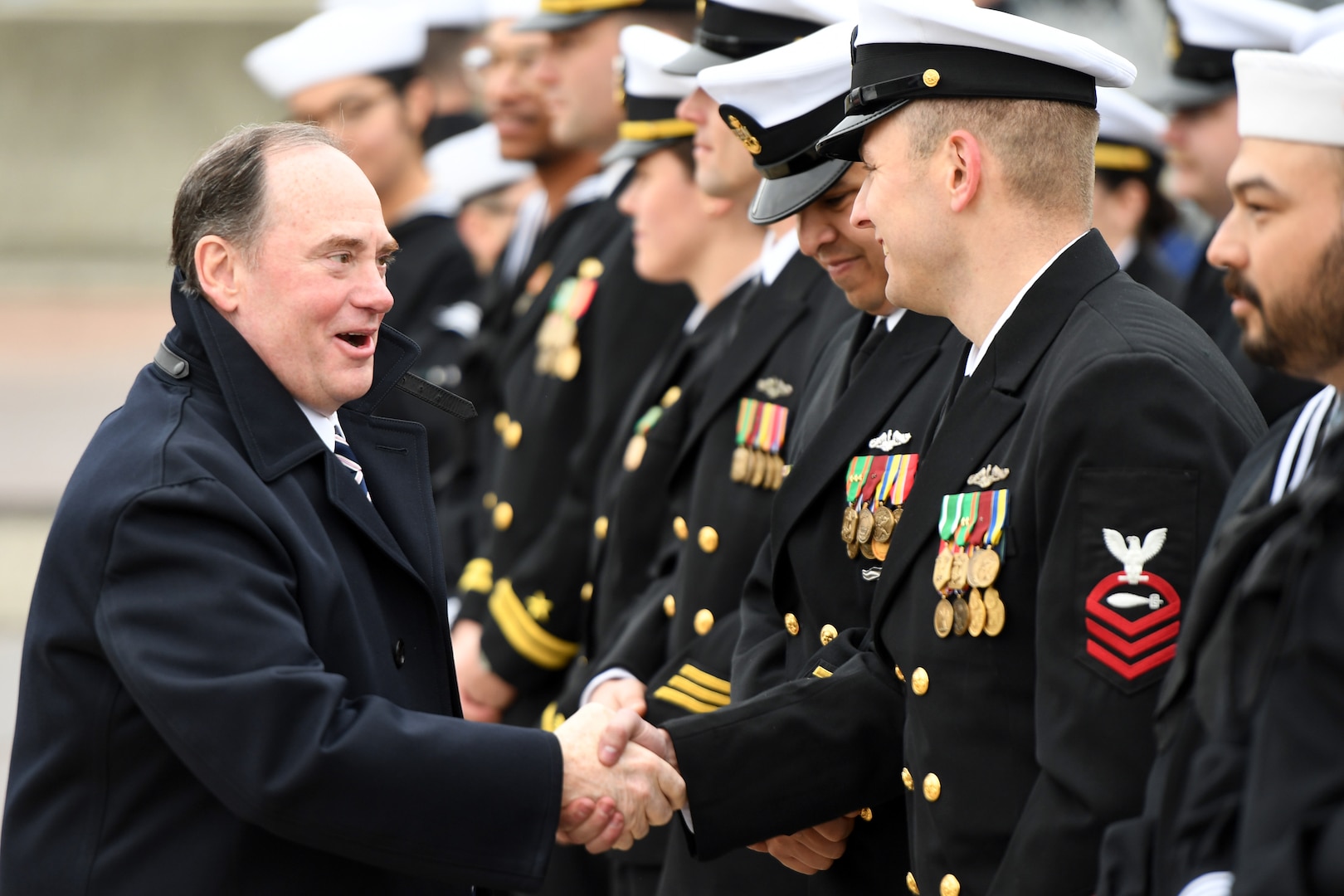 Secretary of the Navy John Phelan greets crewmembers attached to the fast-attack submarine USS Iowa (SSN 797) during a commissioning ceremony in Groton, Connecticut, April 5, 2025.