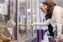 Two people look in a display case.