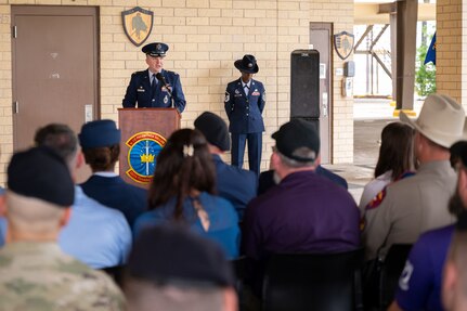 commander stands in front of crowd at a podium