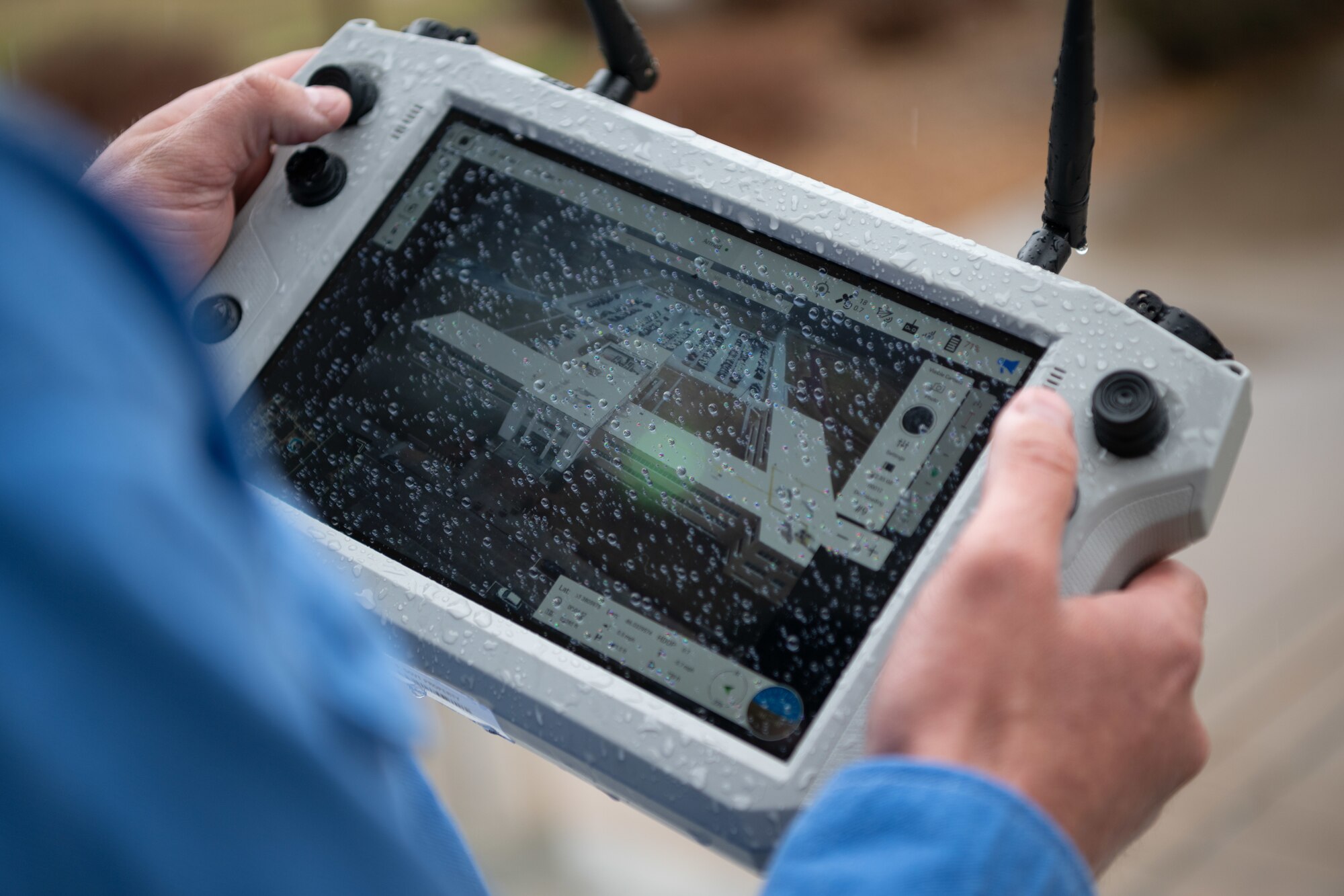 The image from the digital camera of a Small Unmanned Aircraft System, also known as an sUAS or a “drone,” is displayed on the device control held by sUAS operator Robert Hastings during a March 5, 2025, demonstration of the device at Arnold Air Force Base, Tenn. The sUAS will soon be used at Arnold to perform asset health assessments. The device is equipped with both digital and infrared imaging capabilities and will be flown around installation buildings, plant facilities and associated equipment to ensure there are no compromises to such assets and to assess the structural integrity of facilities. (U.S. Air Force photo by Keith Thornburgh)
