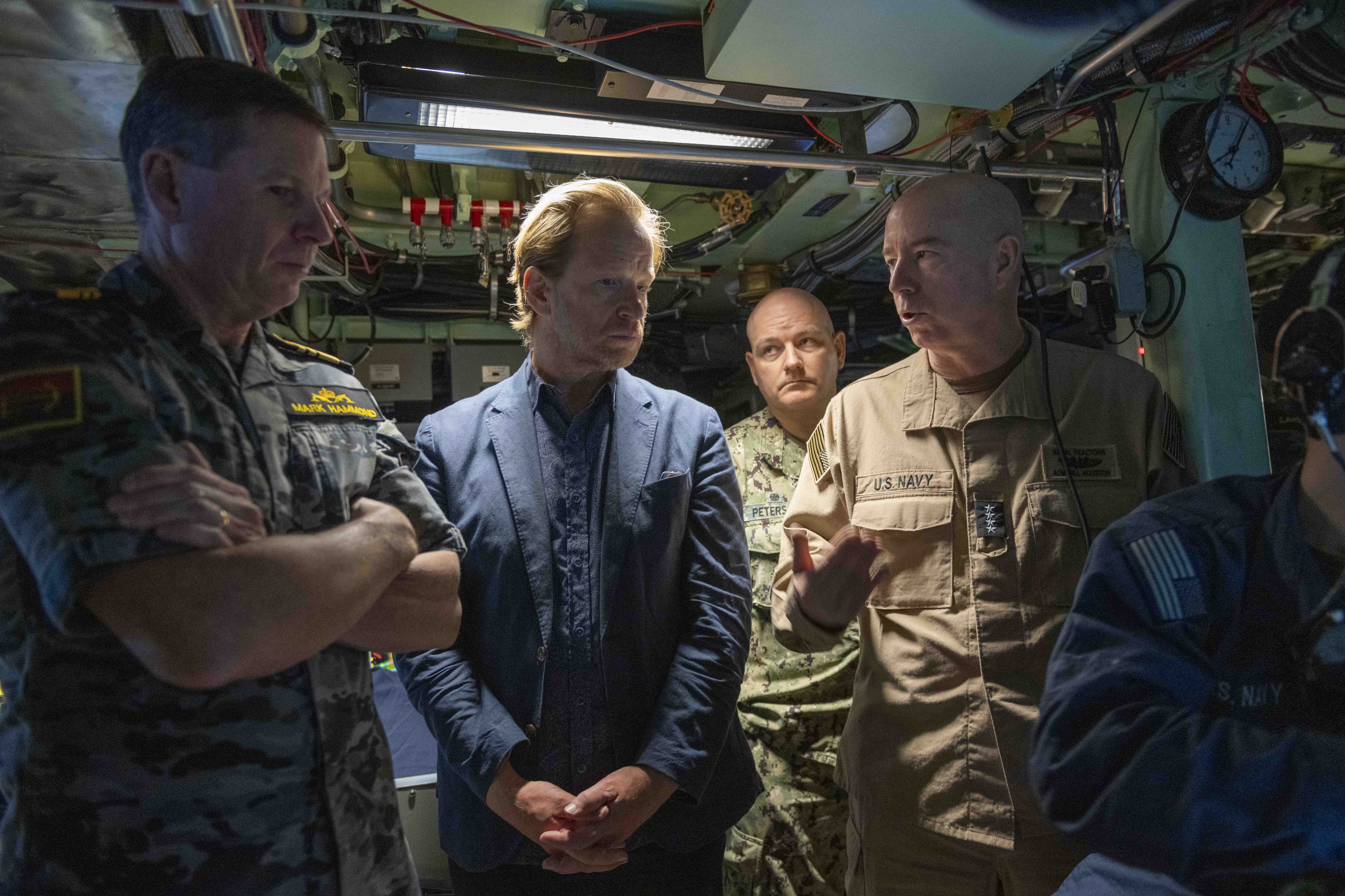 Adm. Bill Houston, director of the Naval Nuclear Propulsion Program, right, discusses the capabilities of Virginia-class fast-attack submarine USS Montana (SSN 794) with Vice Adm. Mark Hammond, chief of the Royal Australian Navy, left, and Greg Wilcock, Australian Consul-General Honolulu, center, during an underway embark aboard Montana, April 3, 2025.