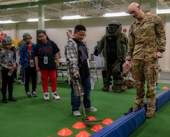An Operation CODE (Children on Deployment Exercise) participant learns how to use a metal detector to find simulated buried ordnances at Misawa Air Base, Japan, April 5, 2025. Through hands-on experiences, children gain insight into their parents’ service while growing closer to the community that supports them. (U.S. Air Force photo by Senior Airman Brittany Russell)
