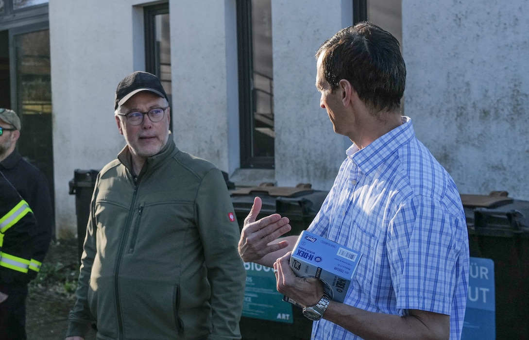 Christian Turner, 52nd Civil Engineer Squadron Environmental Chief, right, and Alois Gerten, the mayor of Spangdahlem welcome volunteers during the opening remarks of the annual Spanger Bach Cleanup in Spangdahlem, Germany, April 5, 2025. The community-led event brought together over 100 local residents, Airmen, and students to remove litter from the village and nearby stream.