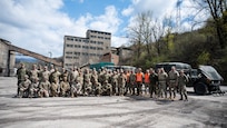 Airmen and Soldiers of the Maryland National Guard and members of the Armed Forces of Bosnia and Herzegovina pose for a group photo after scenario injects of changing a tire and engine repair during a convoy operation from Zenica to Visoko, in Kakanj, Bosnia and Herzegovina, April 7, 2025.