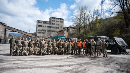 Airmen and Soldiers of the Maryland National Guard and members of the Armed Forces of Bosnia and Herzegovina pose for a group photo after scenario injects of changing a tire and engine repair during a convoy operation from Zenica to Visoko, in Kakanj, Bosnia and Herzegovina, April 7, 2025.