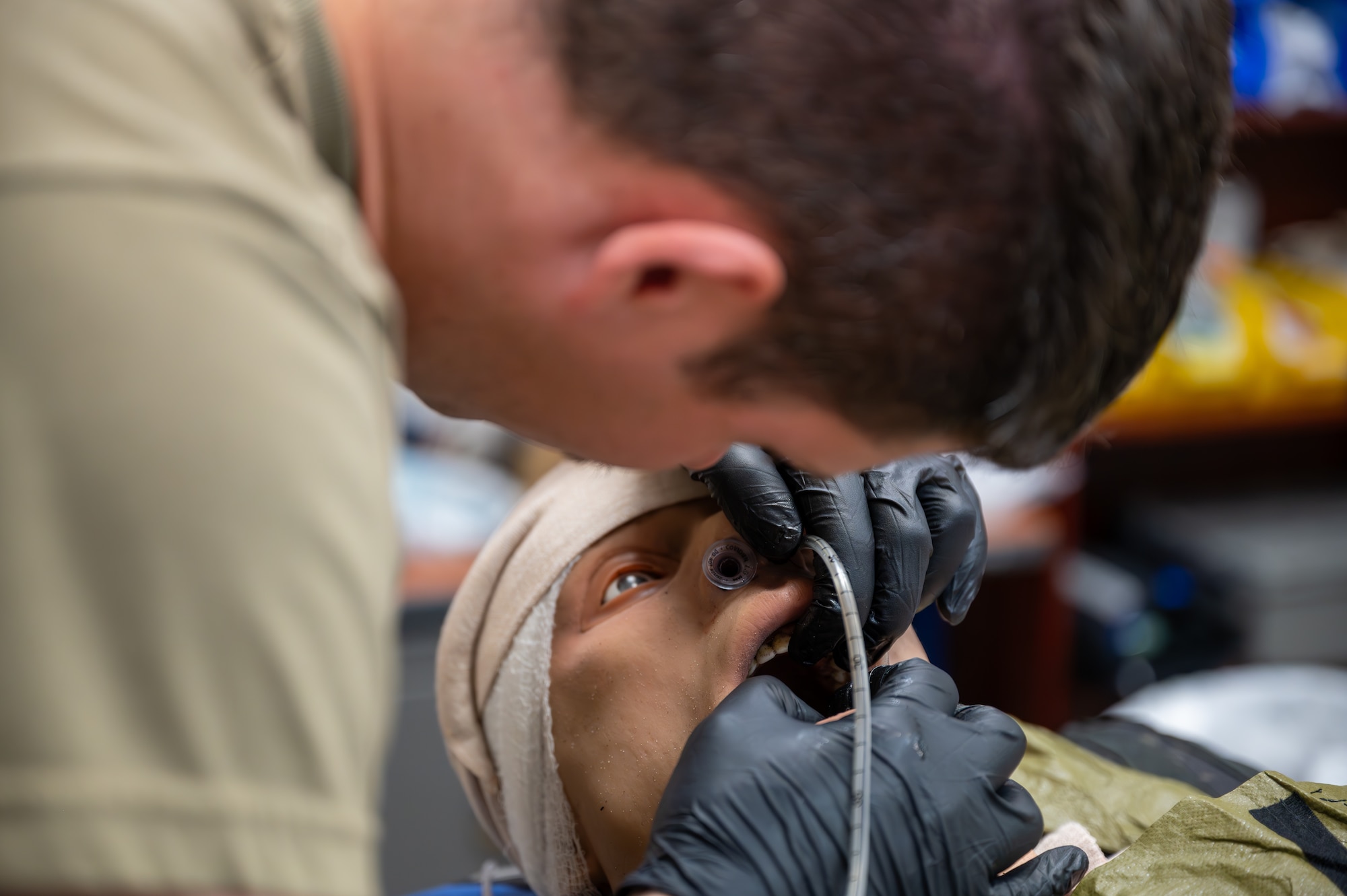 Medical Airman inserts a nasogastric tube into a mannequin.