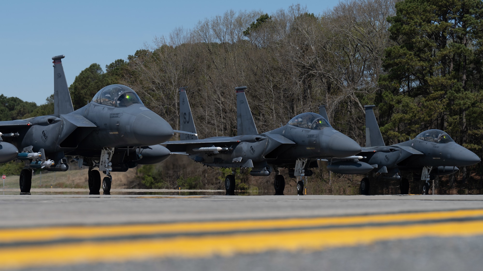 U.S. Air Force F-15E Strike Eagles, assigned to the 4th Fighter Wing, prepare for takeoff at Seymour Johnson Air Force Base, North Carolina, March 26, 2025. The Strike Eagle is best known for its high-speed, deep-strike capabilities. (U.S. Air Force photo by Airman 1st Class Rebecca Tierney)