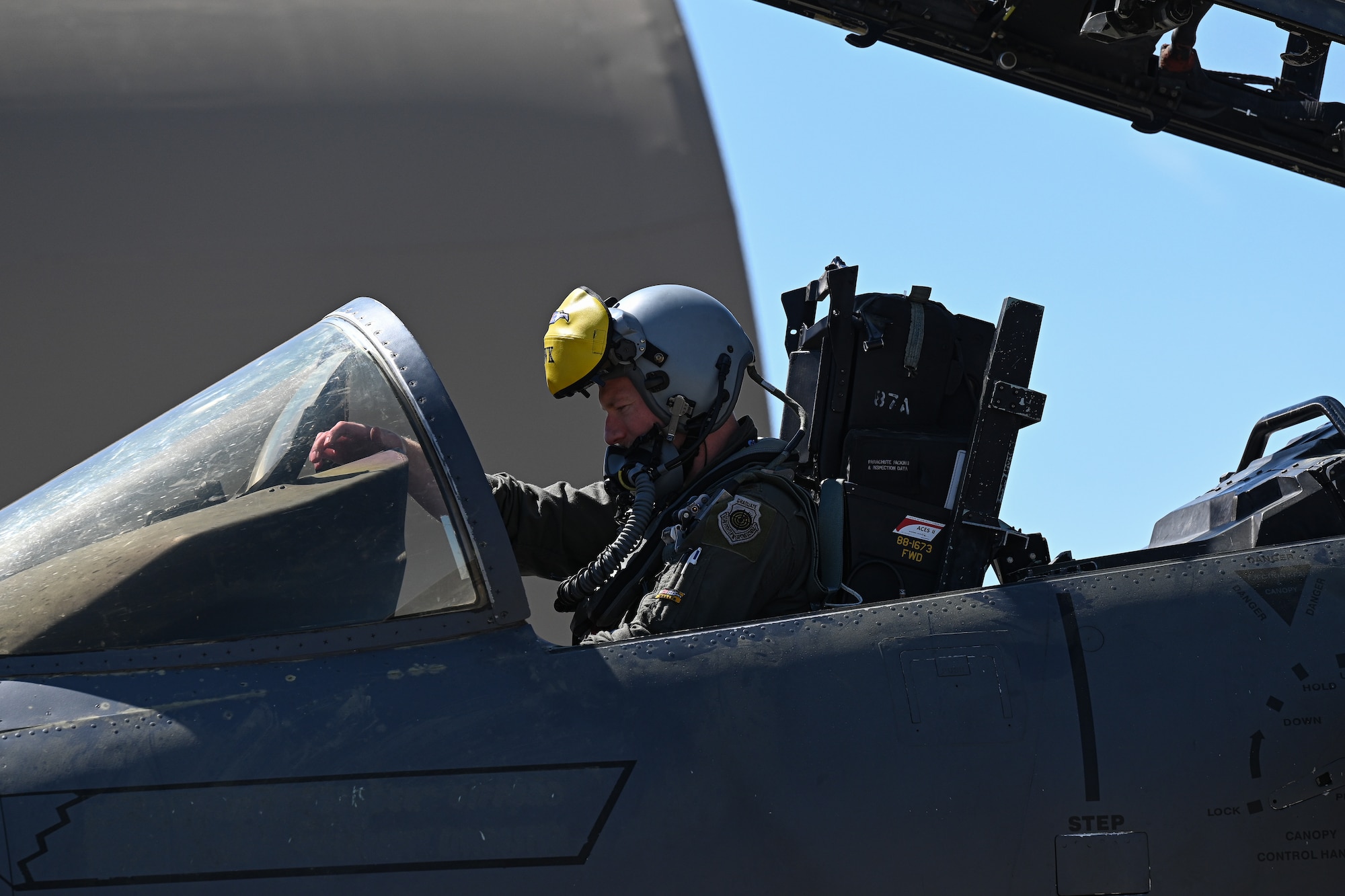 U.S. Air Force Maj. Tray Timmerman, 336th Fighter Squadron pilot, performs pre-flight checks on an F-15E Strike Eagle, at Seymour Johnson Air Force Base, North Carolina, March 26, 2025. The 336th flagship represents the pride and mission of the squadron. (U.S. Air Force photo by Airman Holly Leonard)