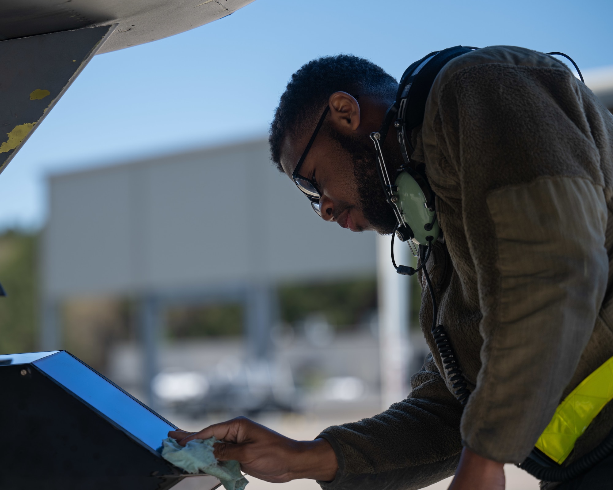 U.S. Air Force Airman 1st Class Bobbie Griffin, 336th Fighter Generation Squadron crew chief, inspects an F-15E Strike Eagle before takeoff at Seymour Johnson Air Force Base, North Carolina, March 26, 2025. Conducting pre-flight checks is vital to the safety of the aircrew. (U.S. Air Force photo by Airman 1st Class Rebecca Tierney)
