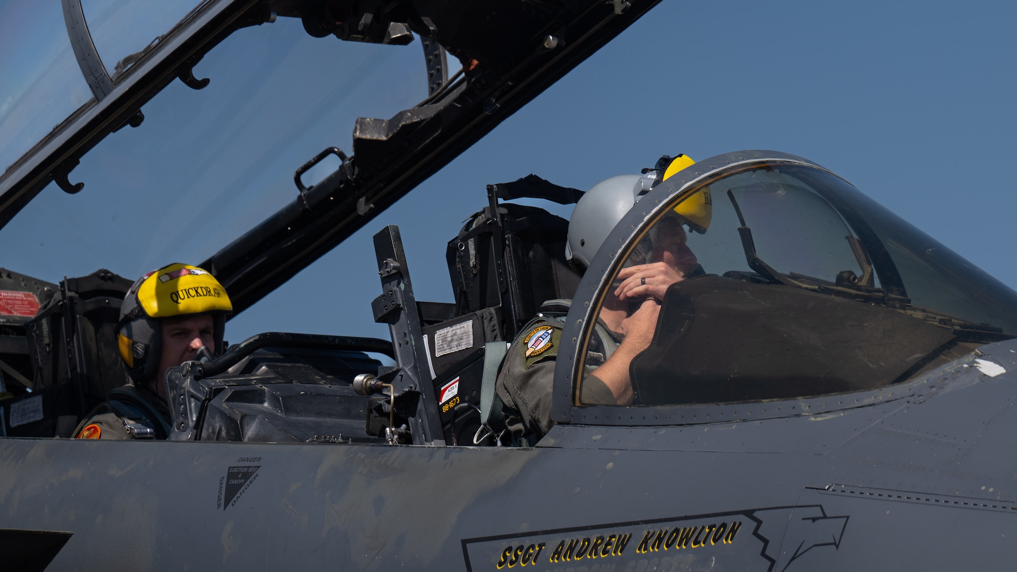 U.S. Air Force Maj. Tray Timmerman, right, 336th Fighter Squadron pilot and Capt. Christopher Strong, left, 336th Fighter Squadron weapons systems officer, adjust their flight helmets, at Seymour Johnson Air Force Base, North Carolina, March 26, 2025. The 336th flagship represents the pride and mission of the squadron. (U.S. Air Force photo by Airman 1st Class Rebecca Tierney)