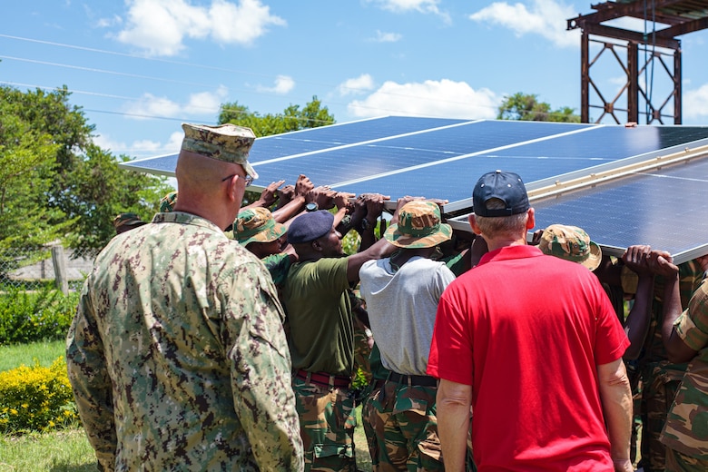 Zambia Defense Force Soldiers mount solar panel on the solar tracker