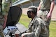 An Airmen works on a satellite dish.